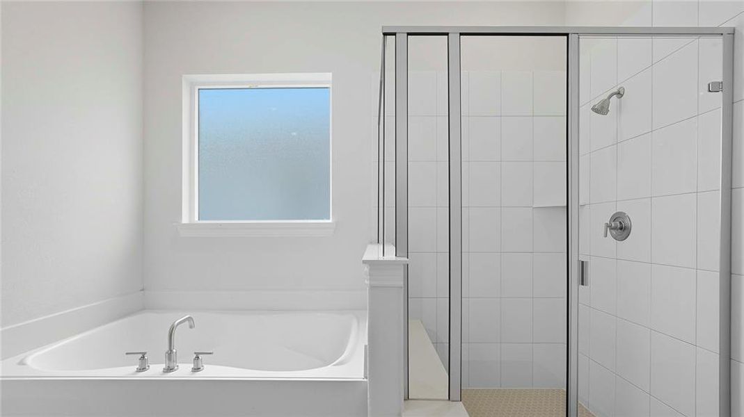 Freestanding soaking tub with chrome fixtures, frosted glass window, and a separate walk-in shower featuring a glass enclosure, white square tile walls, and a tiled shower floor