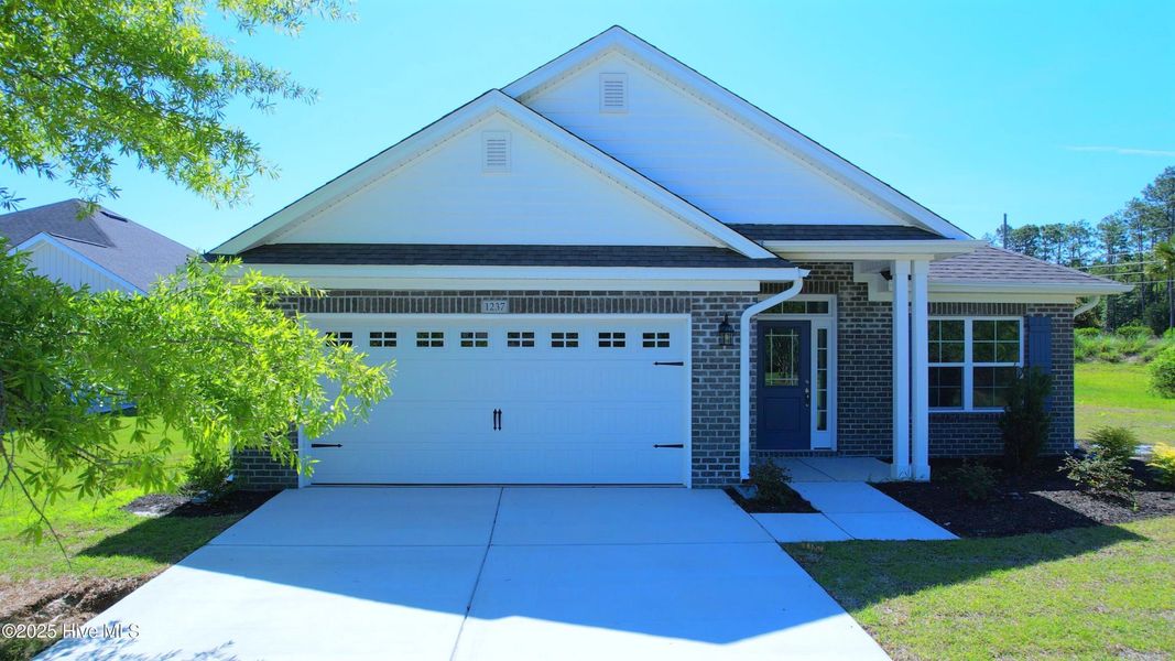 Front exterior of a new home in Palmetto Creek, Bolivia, NC, highlighting curb appeal (Image 2). Front exterior of a new home in Palmetto Creek, Bolivia, NC, highlighting curb appeal (Image 2).