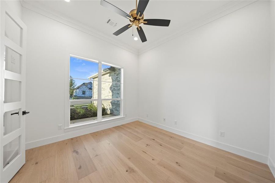Empty room featuring crown molding, light wood-style floors, a ceiling fan, and recessed lighting