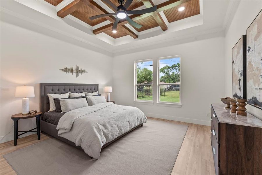 Bedroom featuring coffered ceiling, ornamental molding, beam ceiling, wooden ceiling, and light wood-type flooring Bedroom featuring coffered ceiling, ornamental molding, beam ceiling, wooden ceiling, and light wood-type flooring