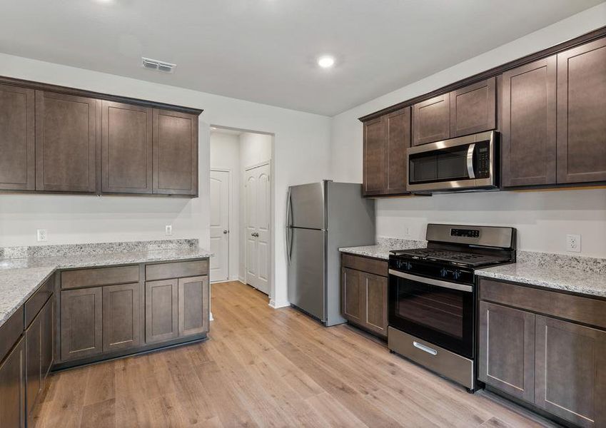 The kitchen has gorgeous wood cabinetry.