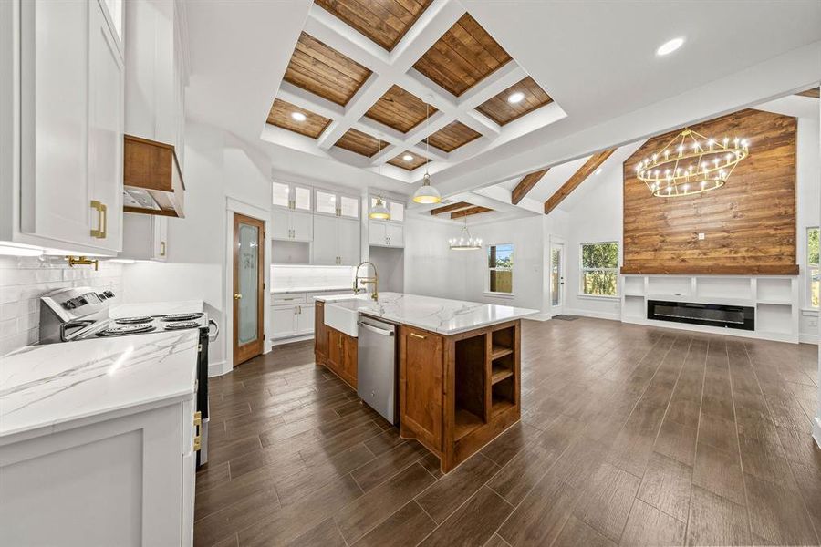 Kitchen with glass insert cabinets, brown cabinets, light stone counters, electric range oven, and decorative backsplash Kitchen with glass insert cabinets, brown cabinets, light stone counters, electric range oven, and decorative backsplash