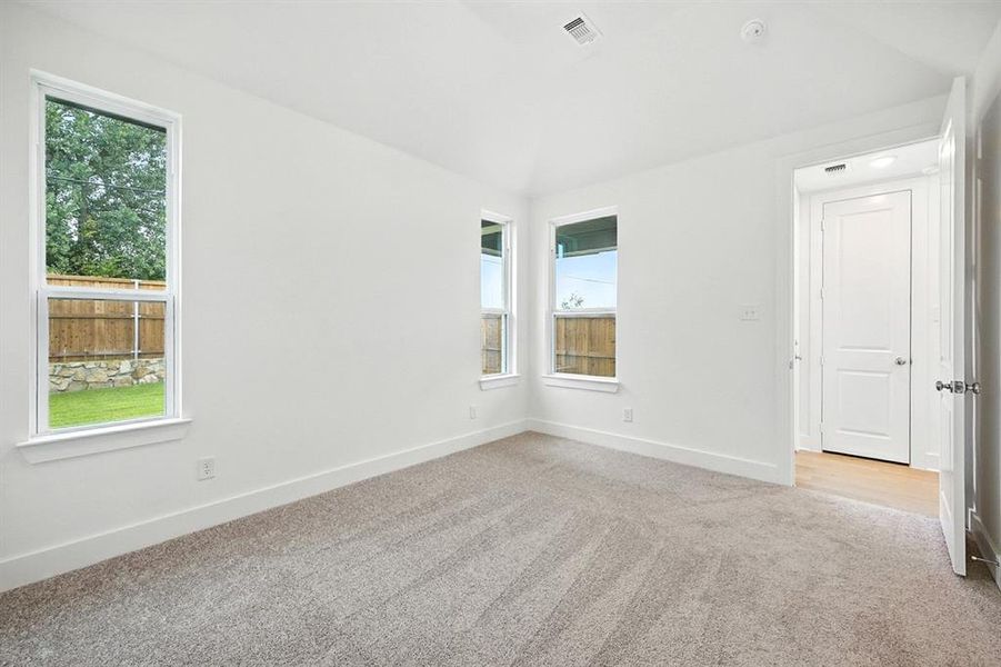 Unfurnished room featuring light colored carpet and baseboards Unfurnished room featuring light colored carpet and baseboards