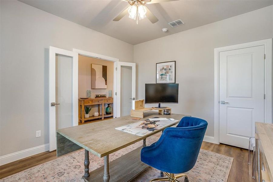 Office with ceiling fan and hardwood / wood-style flooring