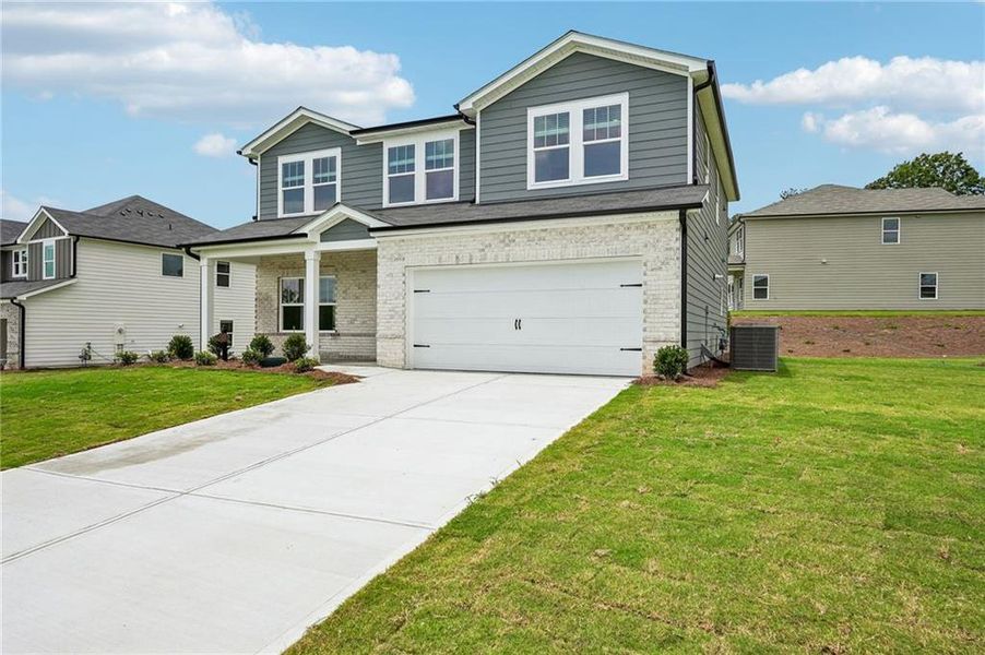 Front exterior of a new home in Northwoods at Mirror Lake, Villa Rica, GA, highlighting curb appeal (Image 28).