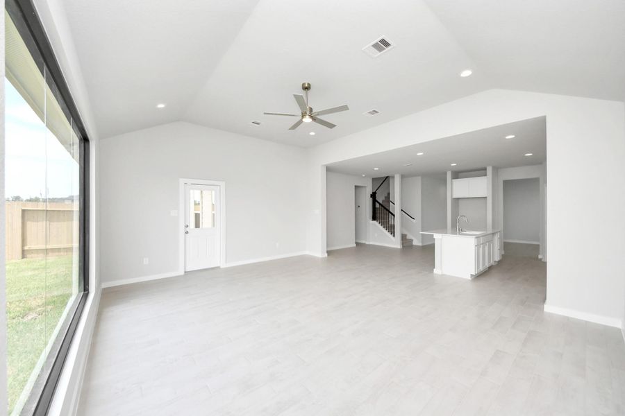 Family room flooded with natural light through the expansive windows. The premium tile flooring adds a touch of luxury to the space, creating the perfect setting for relaxing moments and cherished gatherings with loved ones. Family room flooded with natural light through the expansive windows. The premium tile flooring adds a touch of luxury to the space, creating the perfect setting for relaxing moments and cherished gatherings with loved ones.