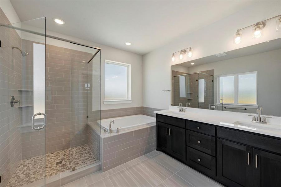 Full bathroom with double vanity, a bath, a shower stall, light tile patterned floors, and recessed lighting