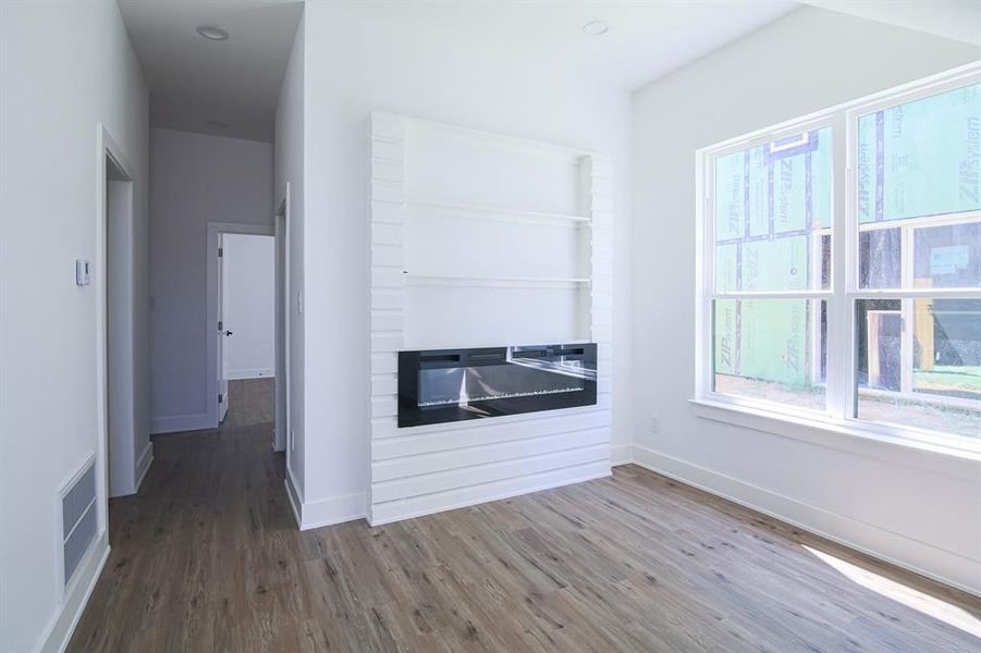 Unfurnished living room with hardwood / wood-style flooring