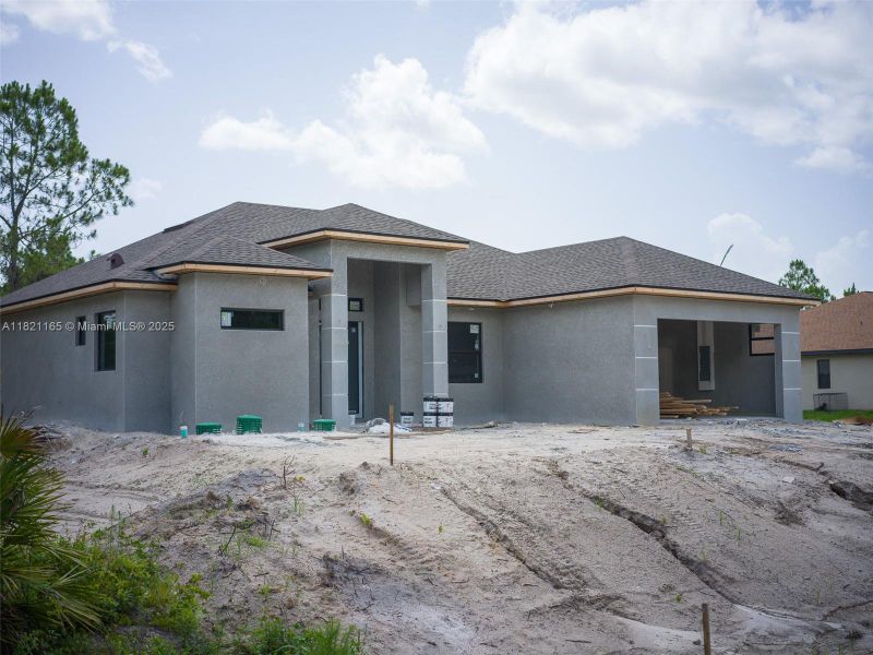 Front exterior of a new home in , Lehigh Acres, FL, highlighting curb appeal (Image 22).