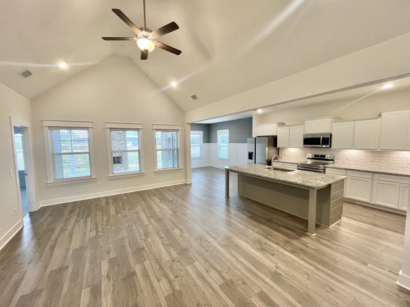 Great room with cathedral ceiling open to kitchen and dining Great room with cathedral ceiling open to kitchen and dining