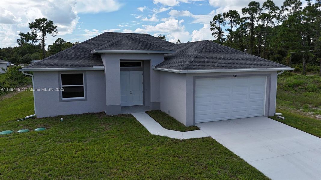 Front exterior of a new home in , Lehigh Acres, FL, highlighting curb appeal (Image 2). Front exterior of a new home in , Lehigh Acres, FL, highlighting curb appeal (Image 2).