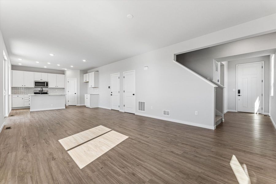 A large empty room with white doors.