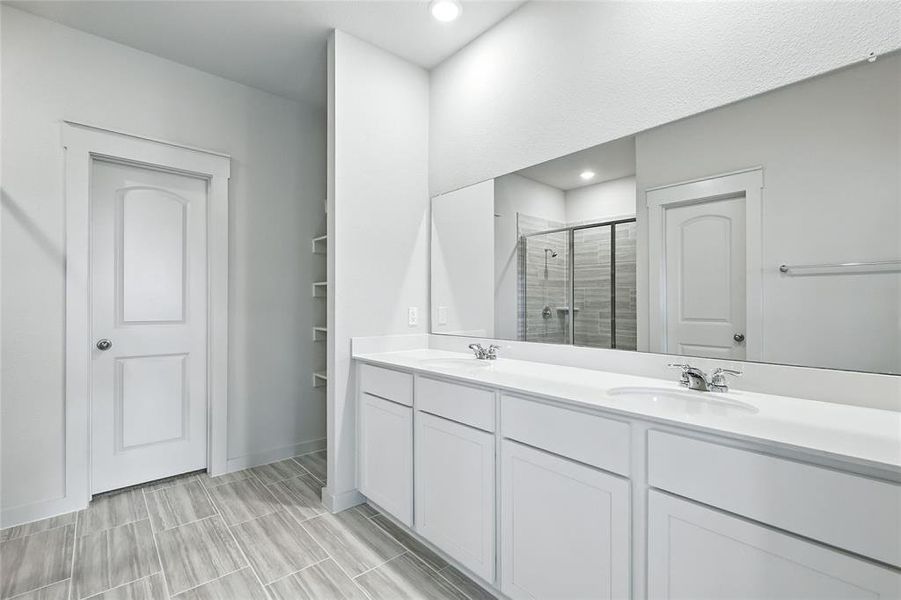 Full bath with a stall shower, double vanity, and recessed lighting Full bath with a stall shower, double vanity, and recessed lighting