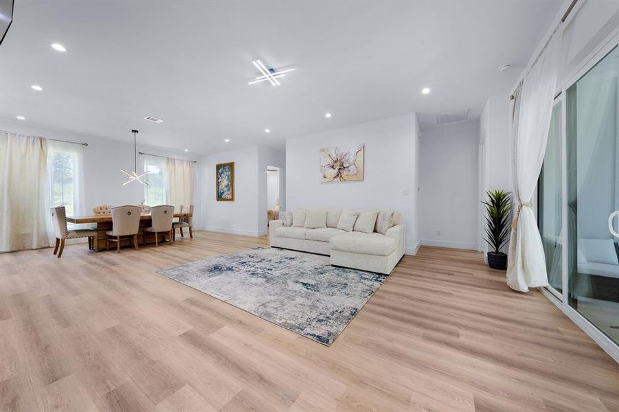 Living area with recessed lighting and light wood finished floors Living area with recessed lighting and light wood finished floors