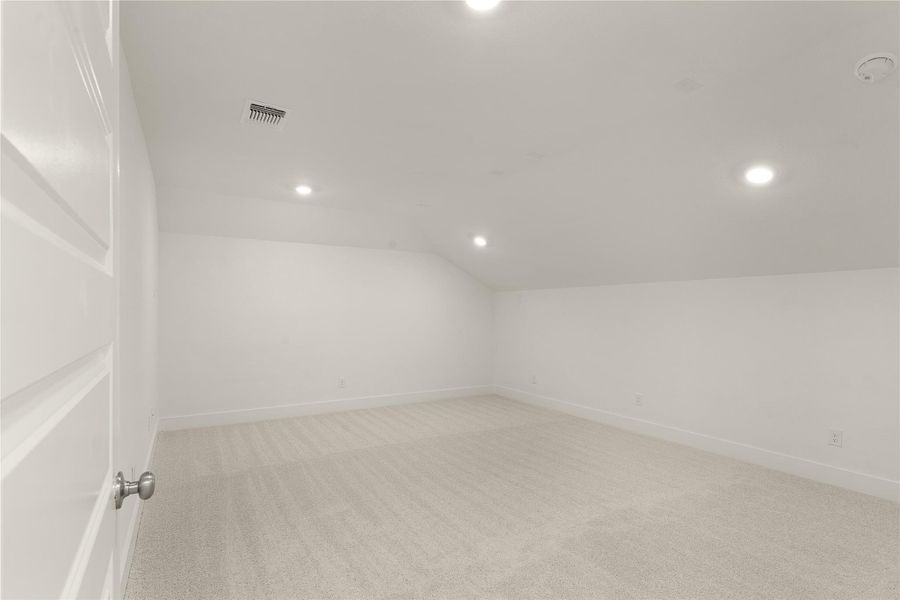 Bonus room featuring light colored carpet, recessed lighting, and vaulted ceiling