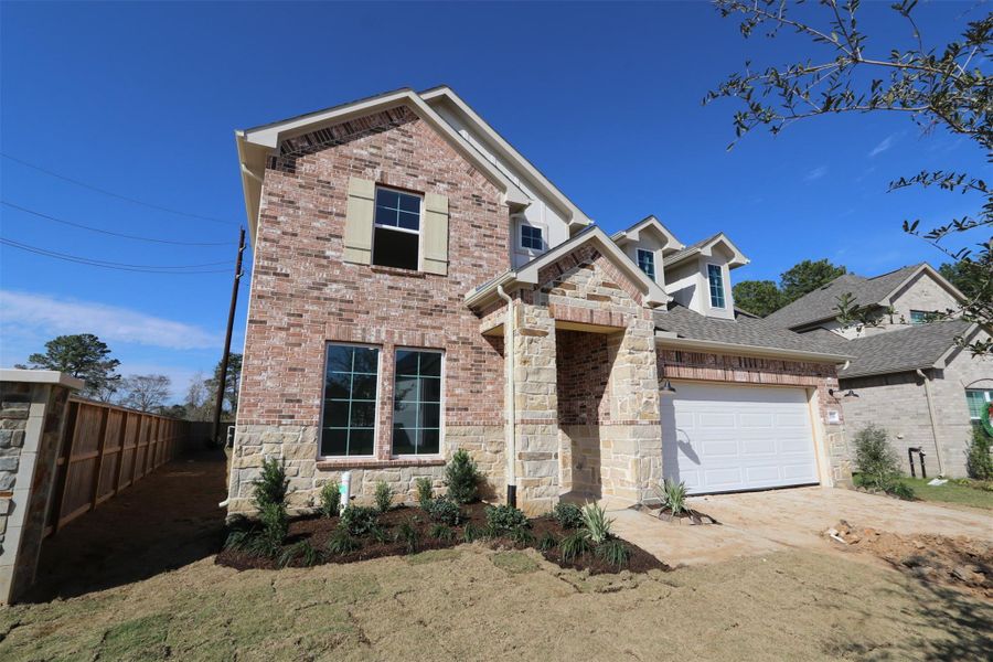 Front exterior of a new home in Sorella, Tomball, TX, highlighting curb appeal (Image 10). Front exterior of a new home in Sorella, Tomball, TX, highlighting curb appeal (Image 10).