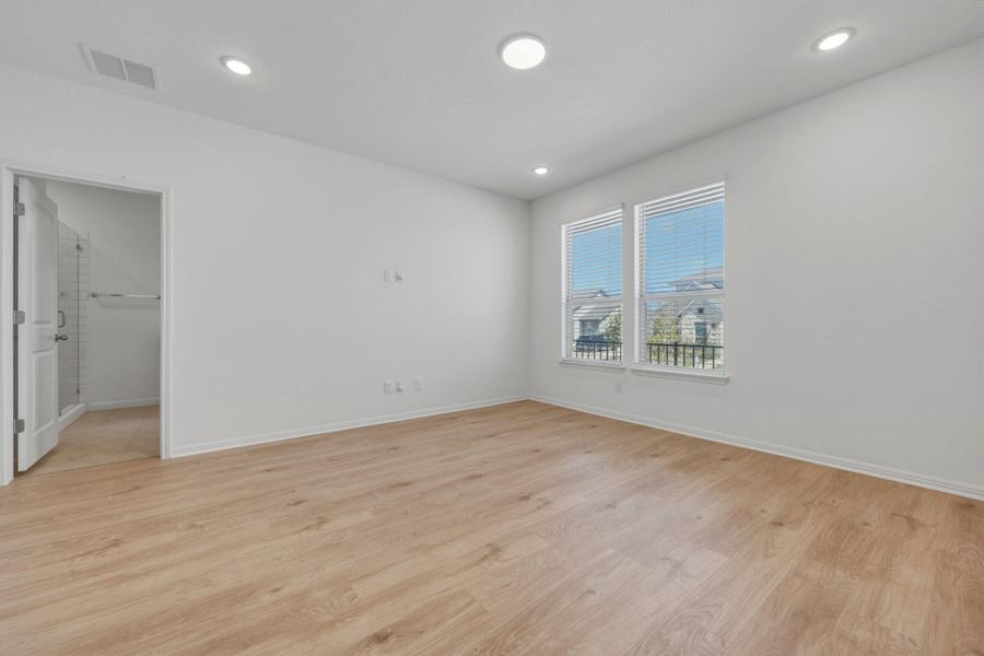 Spare room with light wood-style floors and recessed lighting