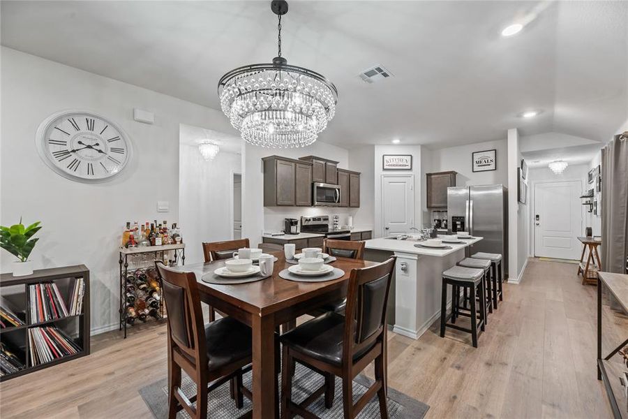Dining room featuring light wood-style floors, a chandelier, and recessed lighting