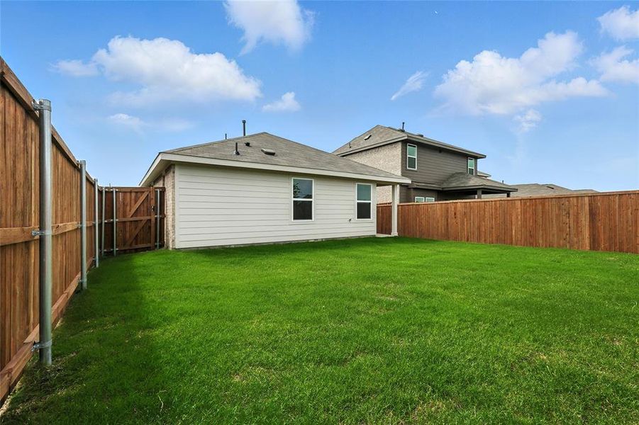 Rear view of house with a fenced backyard Rear view of house with a fenced backyard
