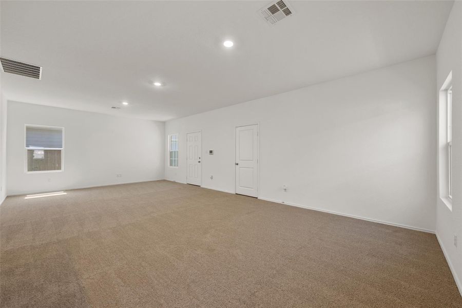 Spare room featuring light carpet and recessed lighting Spare room featuring light carpet and recessed lighting