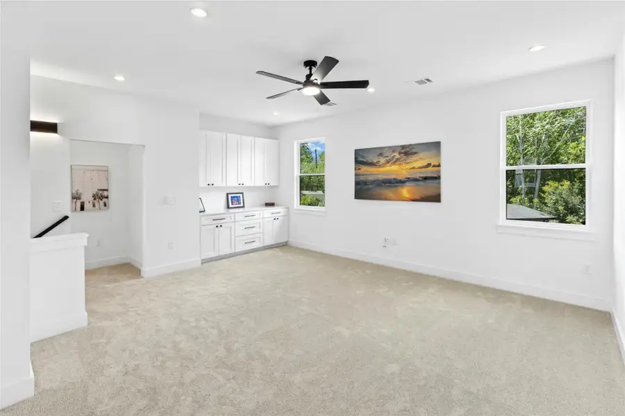 Unfurnished living room with recessed lighting, light colored carpet, and ceiling fan Unfurnished living room with recessed lighting, light colored carpet, and ceiling fan