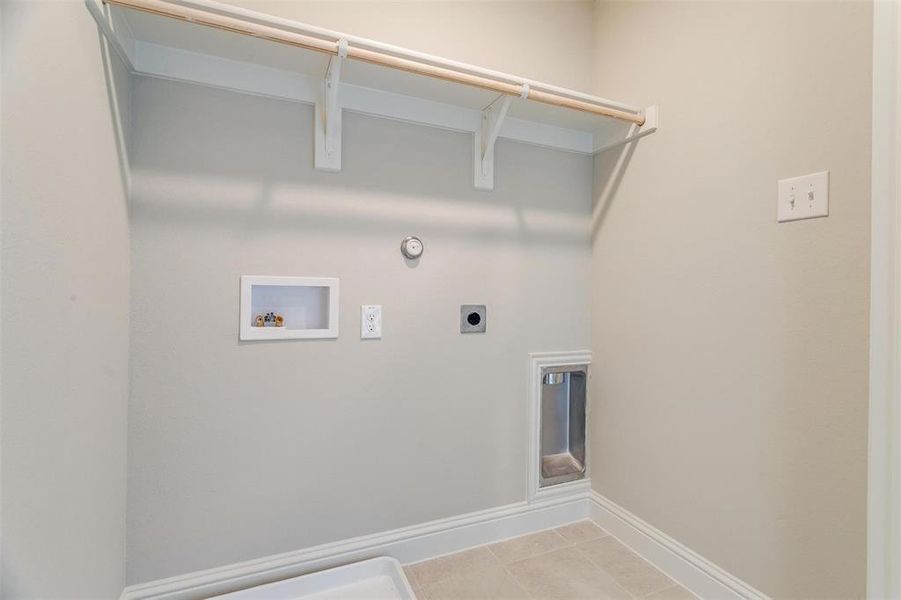 Laundry area featuring hookup for a gas dryer, light tile patterned flooring, electric dryer hookup, and washer hookup
