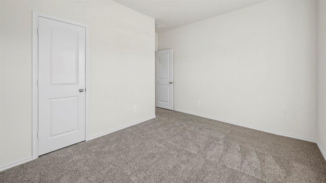 Neutral white wall tones complement the grey-toned carpeting