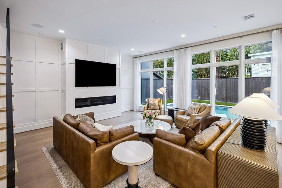 The den offers beautiful views of the stunning pool and backyard, creating a serene and inviting backdrop.