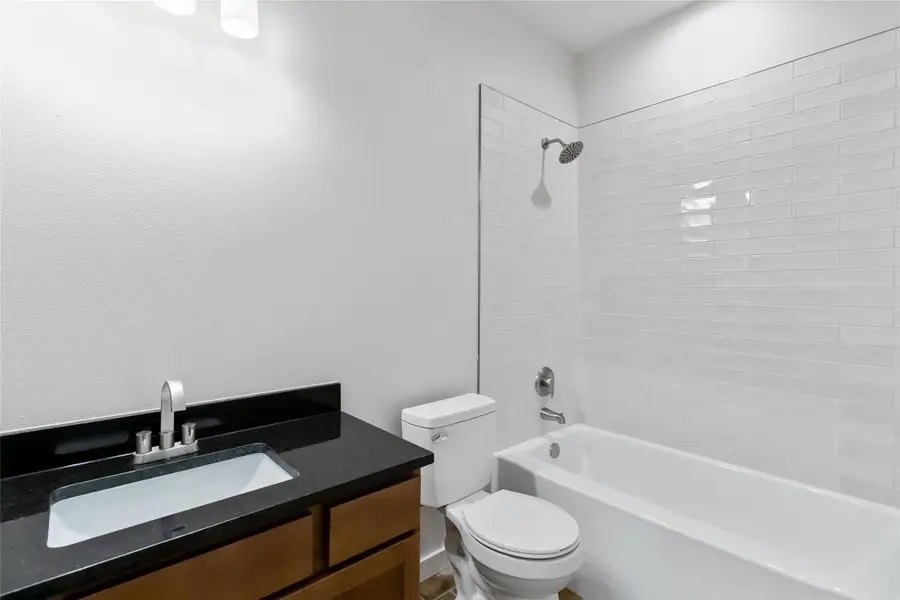Bathroom with vanity and bathing tub / shower combination