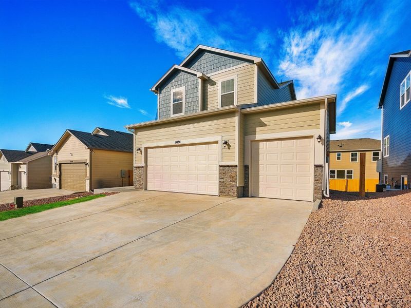 Front exterior of a new home in Ridge at Lorson Ranch, Colorado Springs, CO, highlighting curb appeal (Image 2).