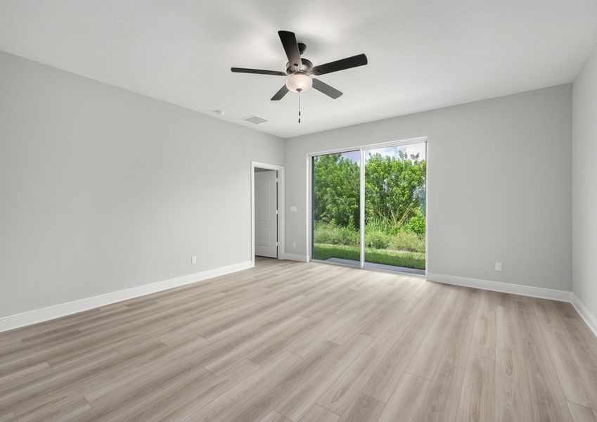 Family room with a glass sliding door that leads to the backyard