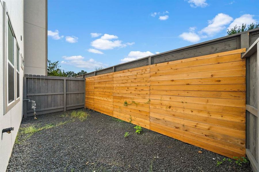 Small fenced and stoned backyard area for grilling and hanging out with your friends and family.