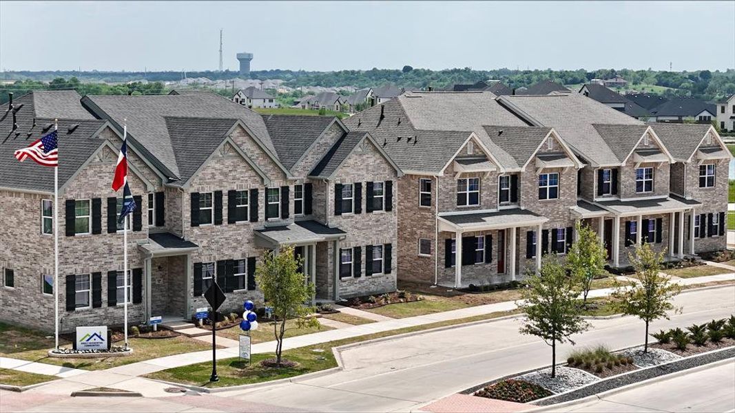 View of front of home featuring a residential view, brick siding, and a shingled roof