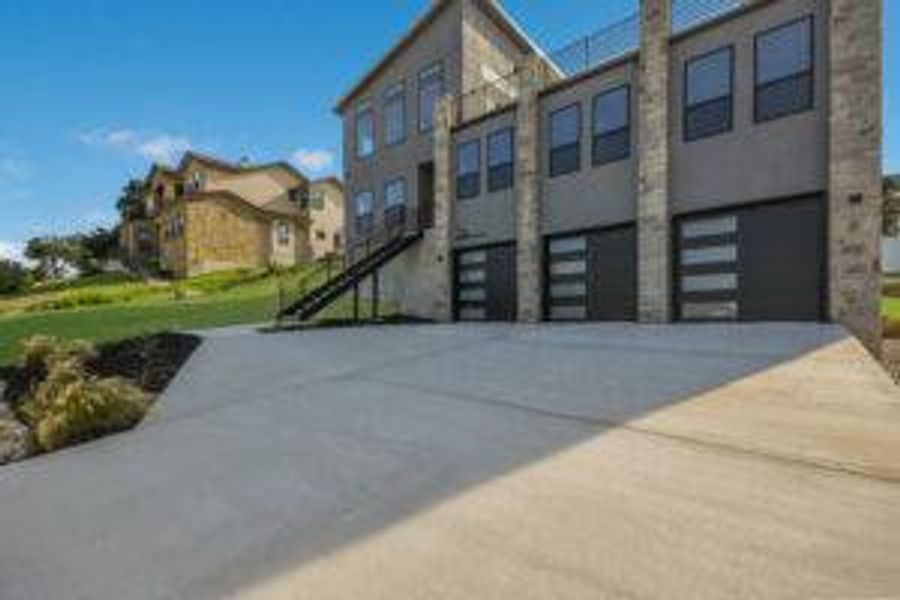 View of front of house with concrete driveway and an attached garage