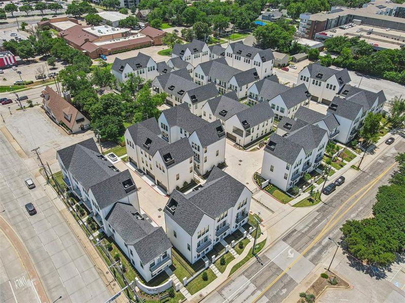 An aerial view of the luxury townhomes reveals a harmonious blend of modern architecture and lush landscaping.