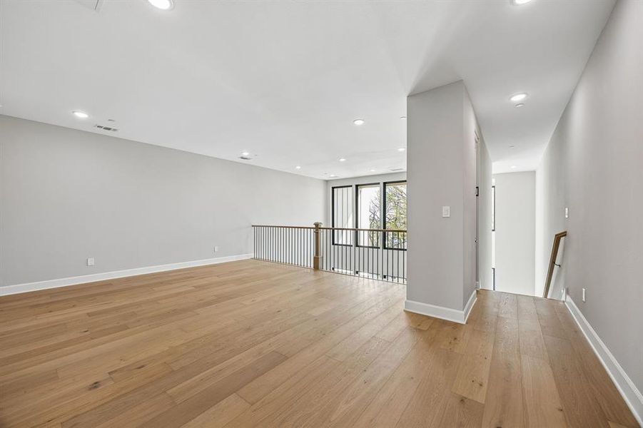 Spare room featuring light wood-type flooring and recessed lighting Spare room featuring light wood-type flooring and recessed lighting