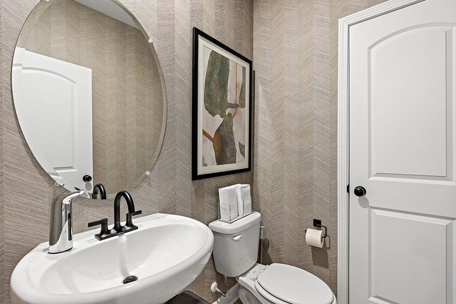 A bathroom with a sink and a mirror. A bathroom with a sink and a mirror.