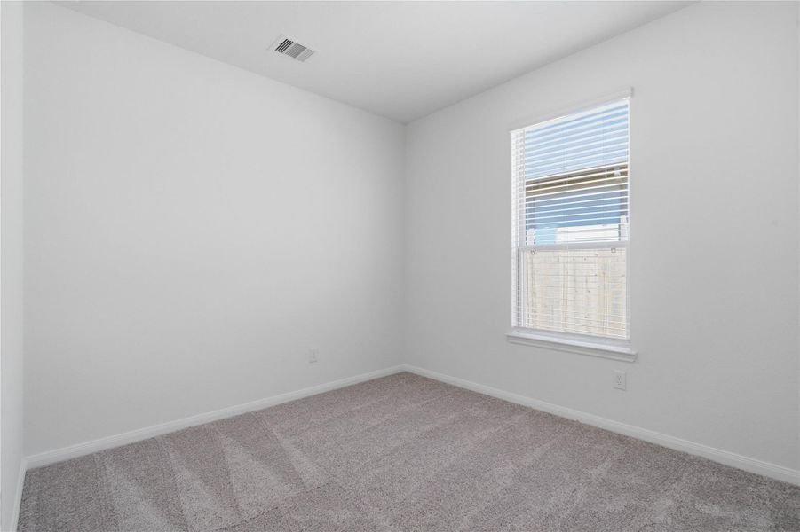 This secondary bedroom offers comfort and style with plush carpeting, neutral paint tones, recessed lighting, a large window with blinds, and a generously sized closet. This secondary bedroom offers comfort and style with plush carpeting, neutral paint tones, recessed lighting, a large window with blinds, and a generously sized closet.