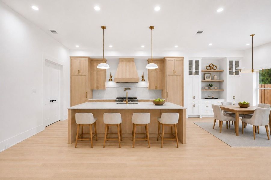 Chef-inspired kitchen boasts custom white oak cabinetry, 42” wood-paneled Thermador refrigerator, a 48" professional gas range with double ovens and an adjacent dining area.