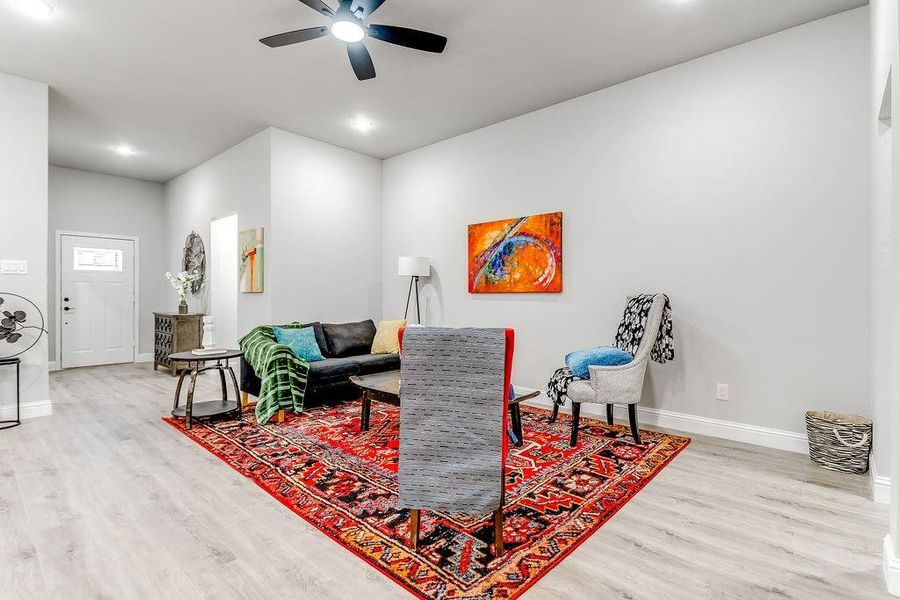 Living room featuring light hardwood / wood-style floors and ceiling fan