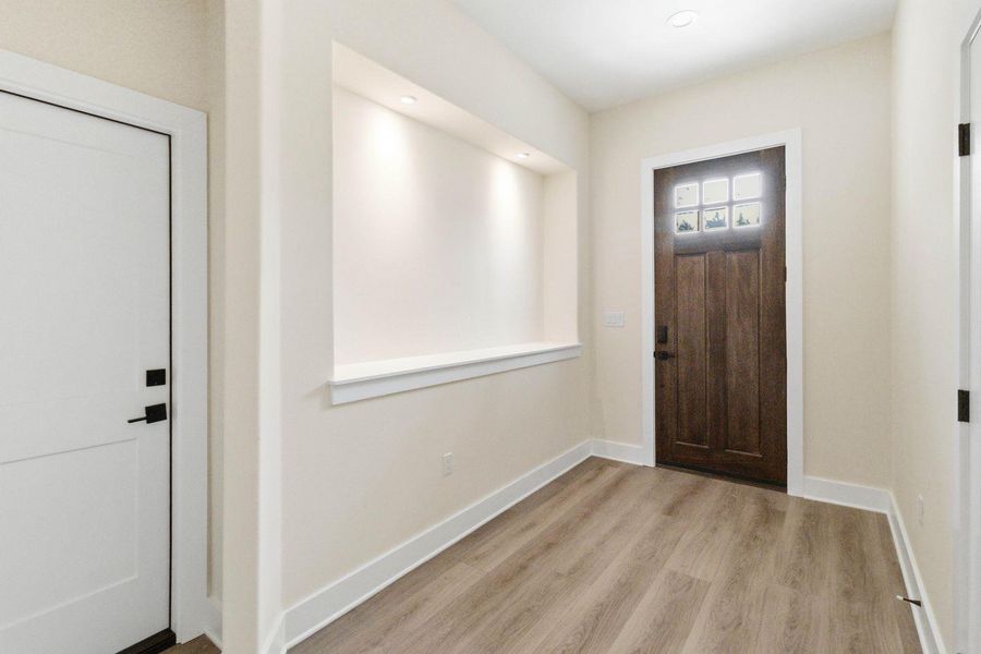 A welcoming entry features recessed lighting and richly toned wood flooring. A welcoming entry features recessed lighting and richly toned wood flooring.