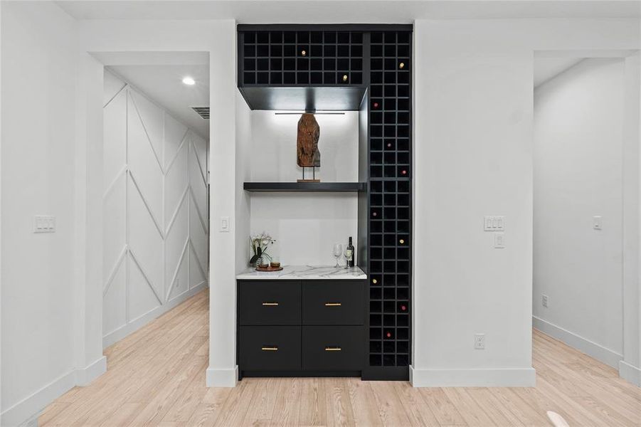 Bar featuring light hardwood / wood-style floors