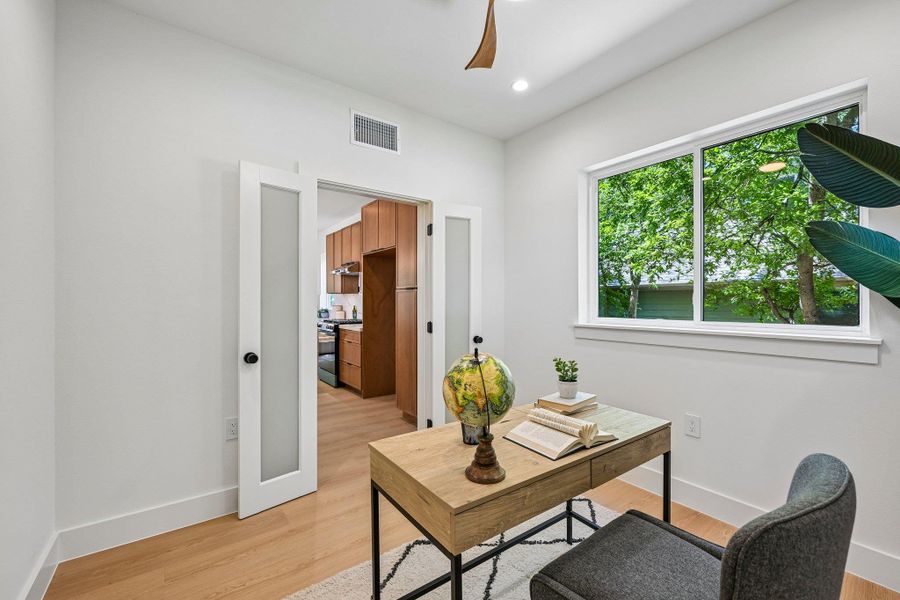 An inviting study with frosted french doors and a large window offers a serene workspace. If no home office is needed, this room could be a formal dining. An inviting study with frosted french doors and a large window offers a serene workspace. If no home office is needed, this room could be a formal dining.