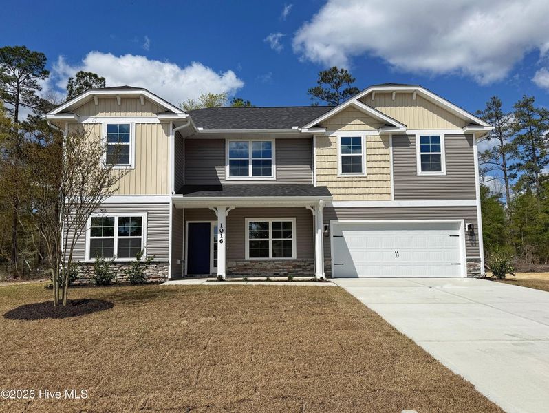 Front exterior of a new home in Wood Creek Landing, Leland, NC, highlighting curb appeal (Image 18).
