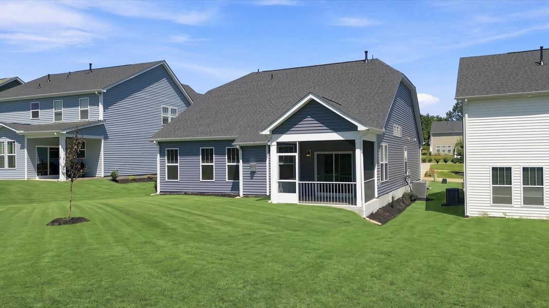 Refined rear exterior with a stylish screened-in porch for dining, relaxing, or entertaining at Fox Hollow