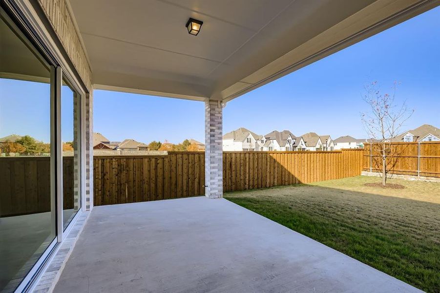 Fenced backyard with a residential view and a patio area
