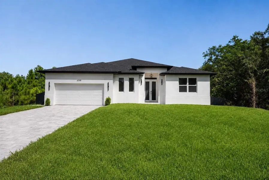 Front exterior of a new home in , North Port, FL, highlighting curb appeal (Image 1). Front exterior of a new home in , North Port, FL, highlighting curb appeal (Image 1).