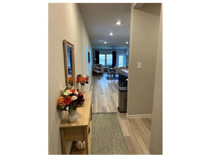 Hallway with light hardwood / wood-style floors