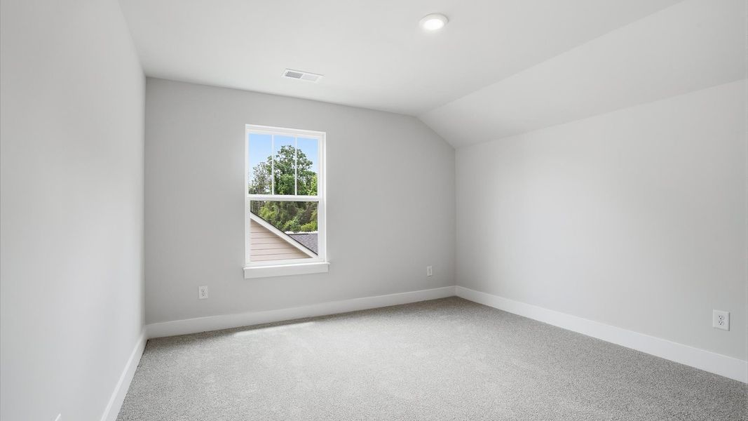 Inviting bedroom with tasteful finishes and a large window that creates a fresh, open ambiance located near Downtown Anderson
