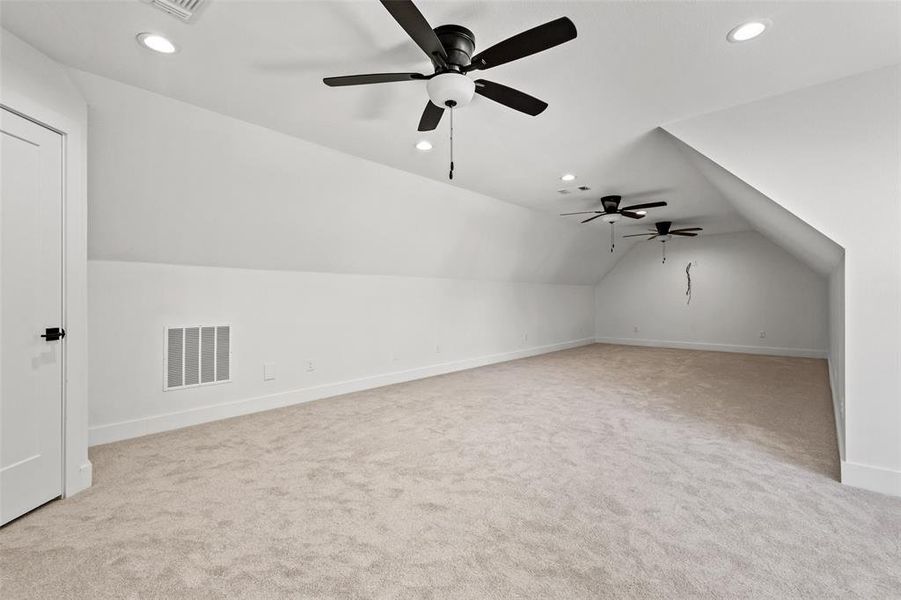 Additional living space with lofted ceiling, recessed lighting, light carpet, and a ceiling fan Additional living space with lofted ceiling, recessed lighting, light carpet, and a ceiling fan